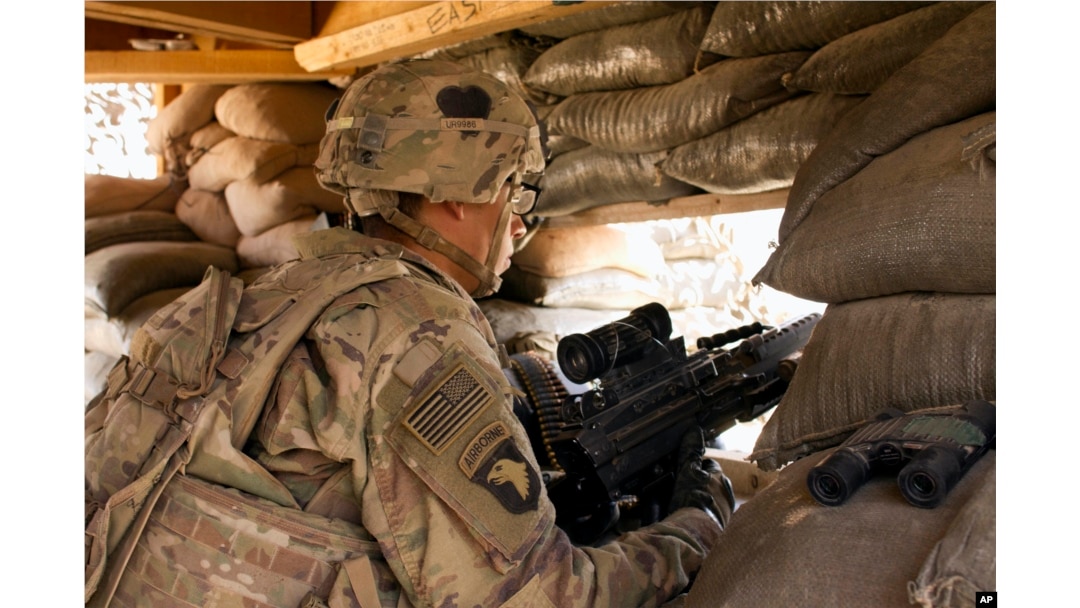 In this Sept. 8, 2016 photo, a U.S. Army soldier guards a position at Camp Swift, northern Iraq. U.S. troops will be engaged more closely than ever in fighting against Islamic State group militants as they back Iraqi forces in the long-anticipated assault on Mosul.