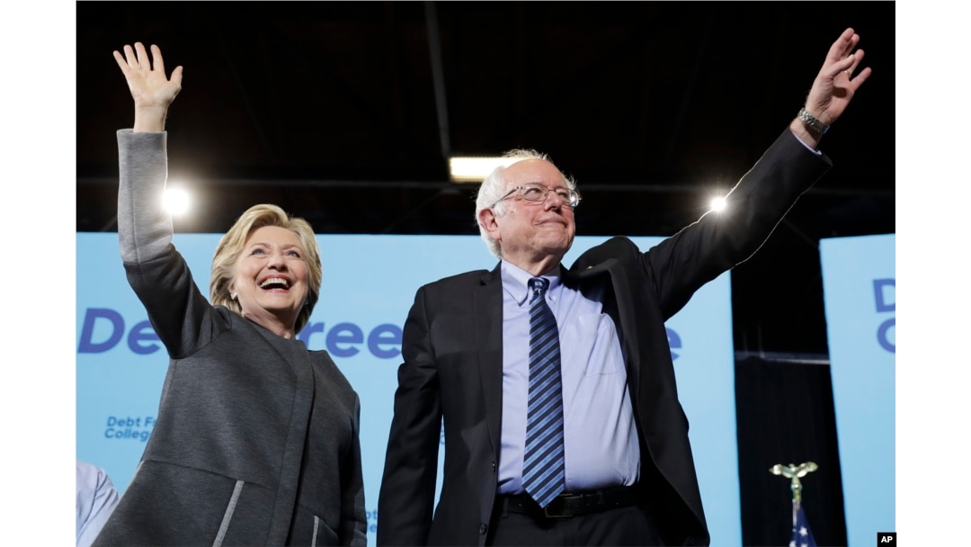 FILE - Democratic presidential candidate Hillary Clinton and Sen. Bernie Sanders, I-Vt., take the stage during a campaign stop in Durham, N.H., Sept. 28, 2016.