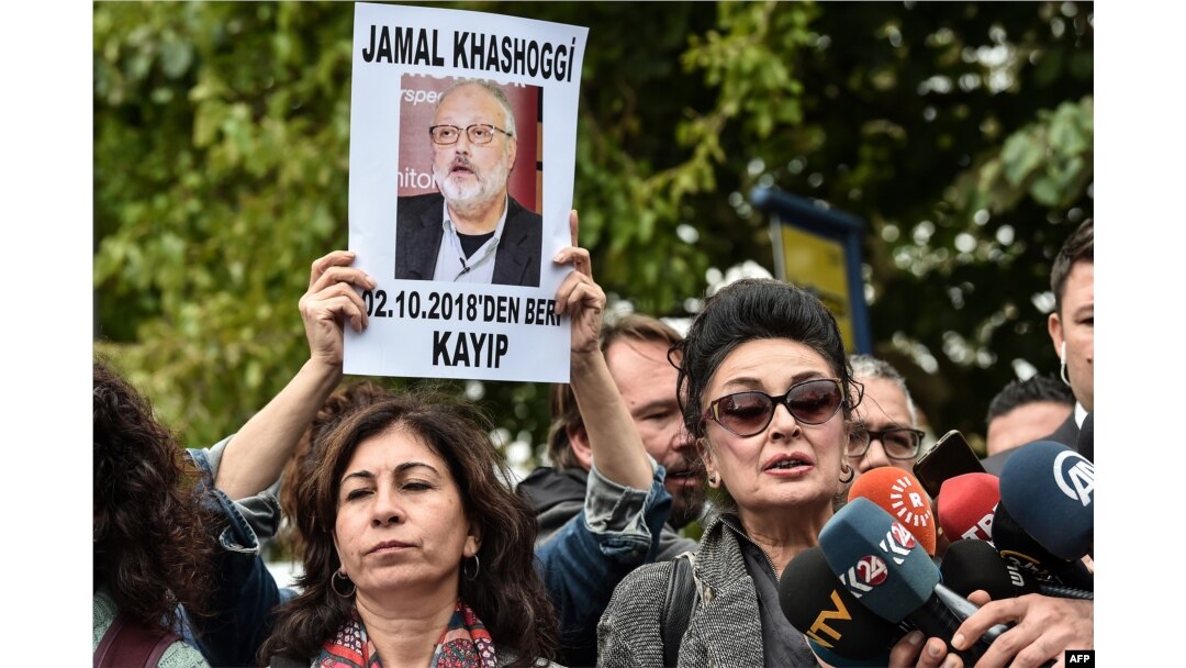 FILE - President of Human Right Association (IHD) Eren Keskin, right, speaks to journalists during a demonstration in front of the Saudi Arabian consulate in Istanbul, in support of missing journalist and Riyadh critic Jamal Khashoggi, Oct. 9, 2018.