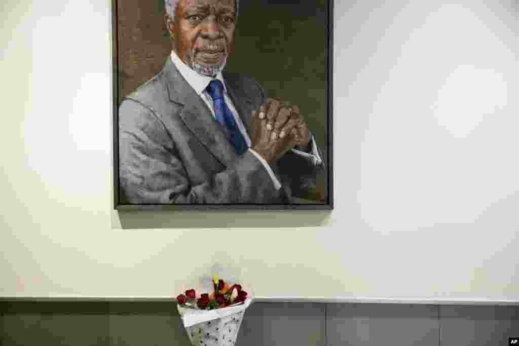 A bouquet of flowers is placed near the portrait of former United Nations Secretary-General Kofi Annan at U.N. headquarters, Aug. 18, 2018. Annan, one of the world's most celebrated diplomats and a charismatic symbol of the United Nations who rose through its ranks to become the first black African secretary-general, has died. He was 80.
