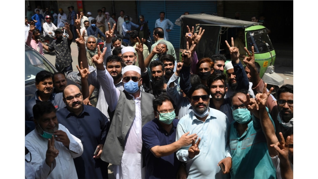 Traders gesture as they protest near their closed shops against a coronavirus lockdown imposed by the Punjab provincial government ahead of the Muslim festival Eid-al-Adha, in Lahore, Pakistan, July 28, 2020.