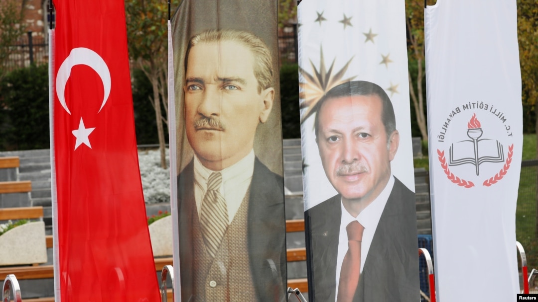 FILE - Banners with pictures of modern Turkey's founder Ataturk and Turkish President Tayyip Erdogan are pictured during the opening ceremony of Recep Tayyip Erdogan Imam Hatip School in Istanbul, Turkey, Sep. 29, 2017. 