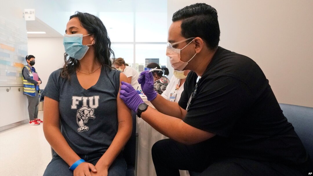 A Florida International University student receives the Pfizer COVID-19 vaccine, April 15, 2021, in Miami.