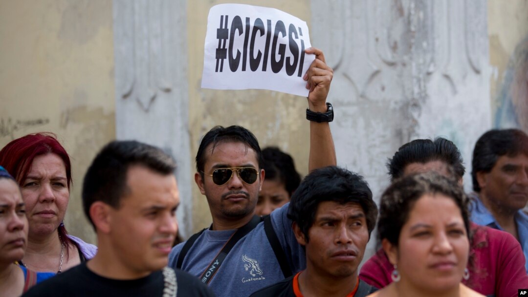 A man holds up a sign that reads in Spanish: "CICIG yes" in reference to the U.N. International Commission Against Impunity, or CICIG, during a protest against Guatemala's President Otto Perez Molina in Guatemala City, April 20, 2015.