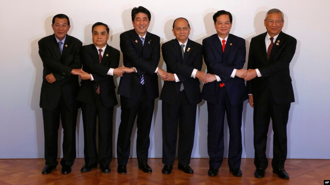 Japanese Prime Minister Shinzo Abe, third from left, join hands with leaders of the Mekong region nations.