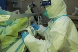 A medical staff attends a patient with pneumonia caused by the new coronavirus at the Zhongnan Hospital of Wuhan University, in Wuhan, Hubei province, China, Jan. 22, 2020.