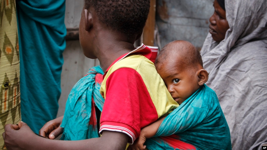 FILE - In this photo taken March 26, 2020, residents live in crowded conditions in the Sayidka camp for internally displaced people in Mogadishu, Somalia. 