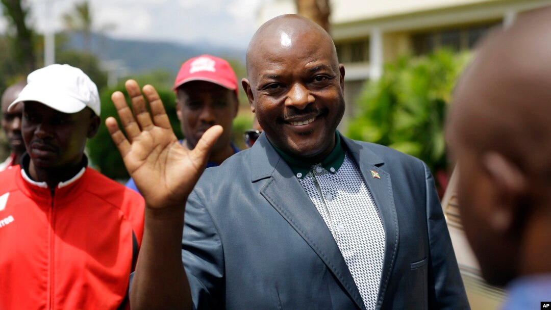FILE - Burundi President Pierre Nkurunziza waves as he walks to his car after making a brief statement to the media at the presidential palace in Bujumbura, Burundi, May 17, 2015. 