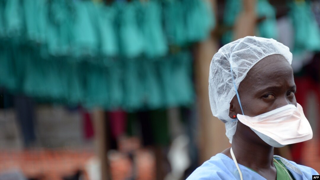FILE - A health worker stands at Elwa hospital in Monrovia in Sept. 2014.