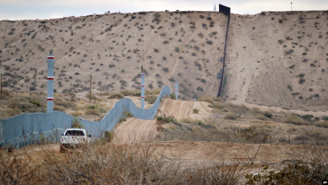 FILE - A U.S. Border Patrol agent drives near the U.S.-Mexico border fence in Sunland Park, New Mexico, Jan. 4, 2016. Trump pledges to replace the fence with a wall that Mexico will pay for.