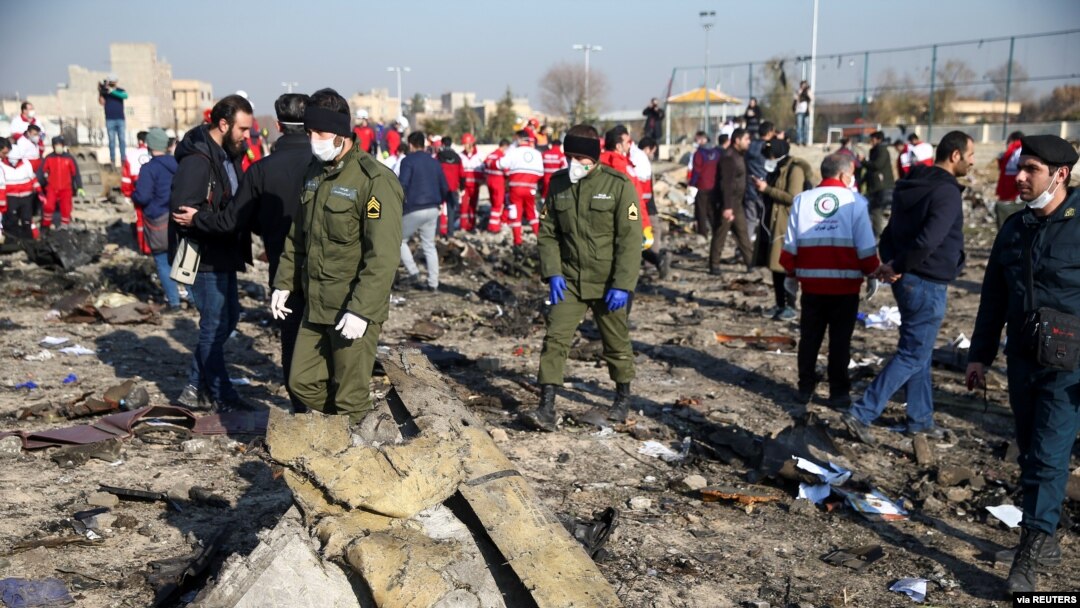 Security officers and Red Crescent workers are seen at the site where the Ukraine International Airlines plane crashed after takeoff from Iran's Imam Khomeini airport, on the outskirts of Tehran, Jan. 8, 2020.