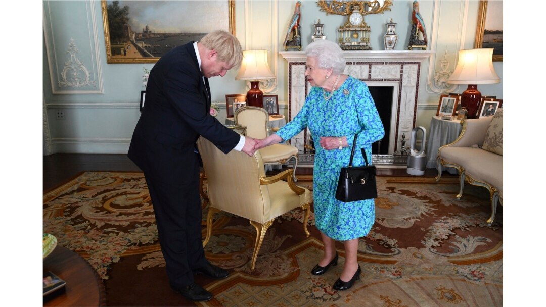 FILE - Britain's Queen Elizabeth II welcomes Boris Johnson, then newly-elected leader of the Conservative party, during an audience at Buckingham Palace, London, England, July 24, 2019.