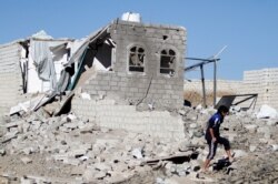A boy is seen at the site of an airstrike launched by the Saudi-led coalition in Sana'a, Yemen, Feb. 1, 2019.