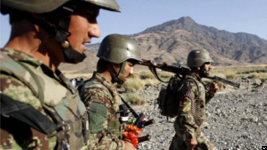 Afghan soldiers carry their weapons during a joint military patrol with US soldiers from Alpha Co, 2nd Battalion 35th Infantry, Task Force 'Cacti' in Walay valley, near the Afghanistan-Pakistan border in Kunar province, October 2, 2011.