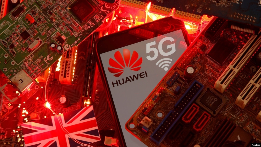 FILE - The British flag and a smartphone with a Huawei and 5G network logo are seen on a PC motherboard in this illustration picture taken January 29, 2020.