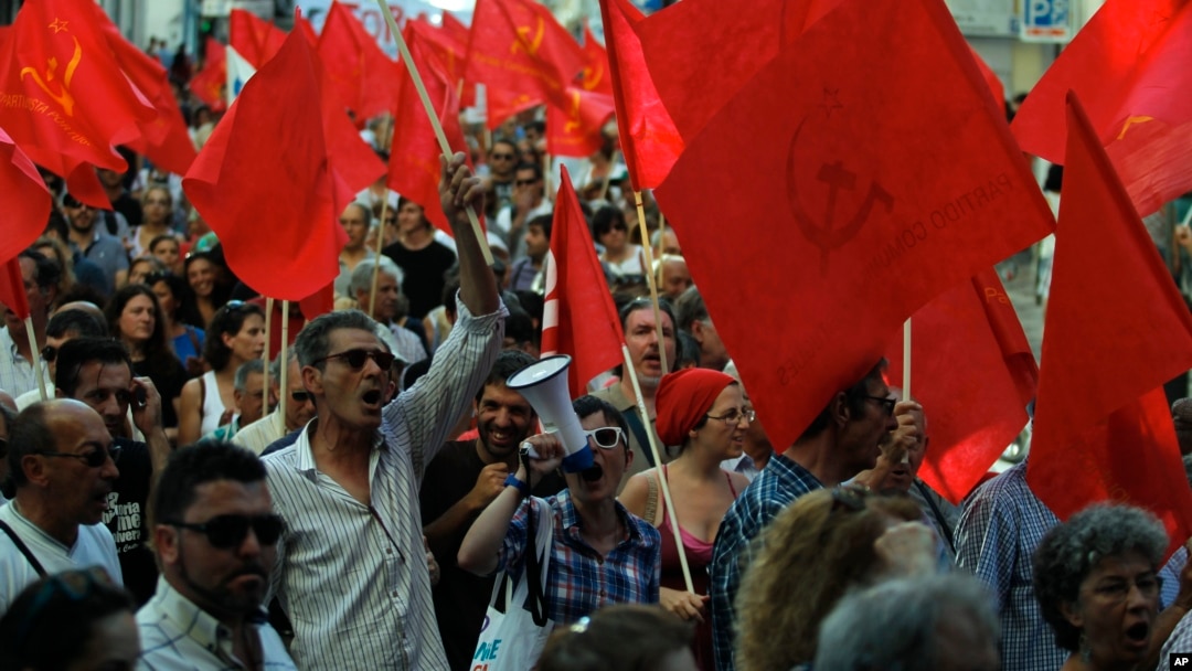 People shout slogans during a protest by the Portuguese Communist party, demanding the breakup of the Portuguese parliament and early elections, in Lisbon, July 3, 2013.