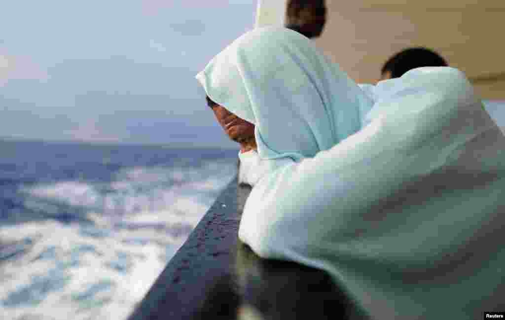 A migrant sits on board NGO Proactiva Open Arms rescue boat in central Mediterranean Sea.