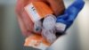 A Cataldo Ambulance medic holds used doses of naloxone after medics revived a man in his 40s who was found unresponsive from an opioid overdose in the Boston suburb of Salem, Massachusetts, Aug. 9, 2017. 