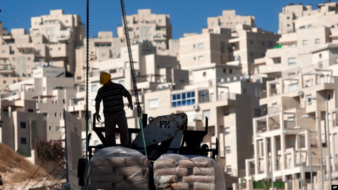 A construction worker works on a new housing unit in the east Jerusalem neighborhood of Har Homa. (File)