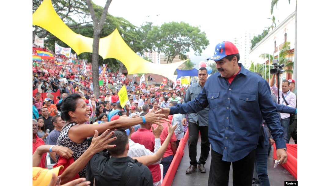 Venezuela's President Nicolas Maduro greets supporters during a rally in support of the Venezuelan government's housing programs at Miraflores Palace in Caracas, Venezuela, May 11, 2016.