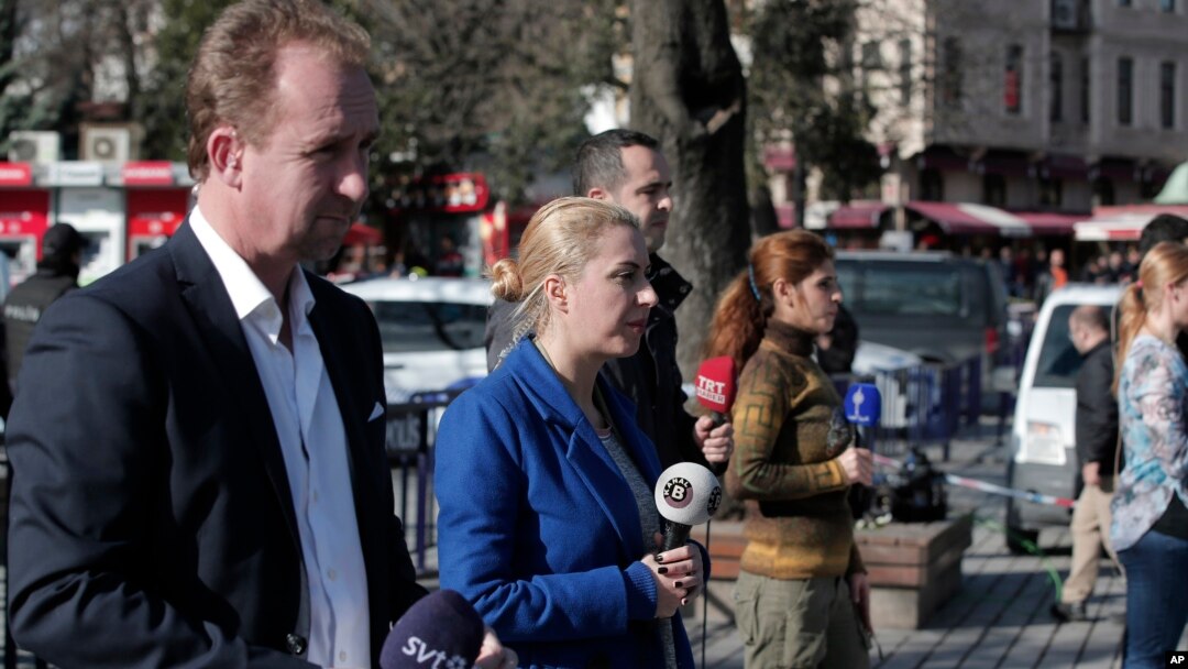Members of the media report at the area of an explosion in the historic Sultanahmet district of Istanbul, Tuesday, Jan. 12, 2016. 