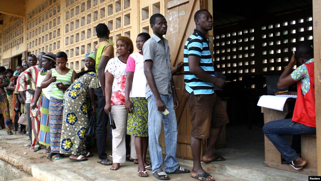 Voters are seen lining up to cast their ballots in Lome, Togo, July 25, 2013. 
