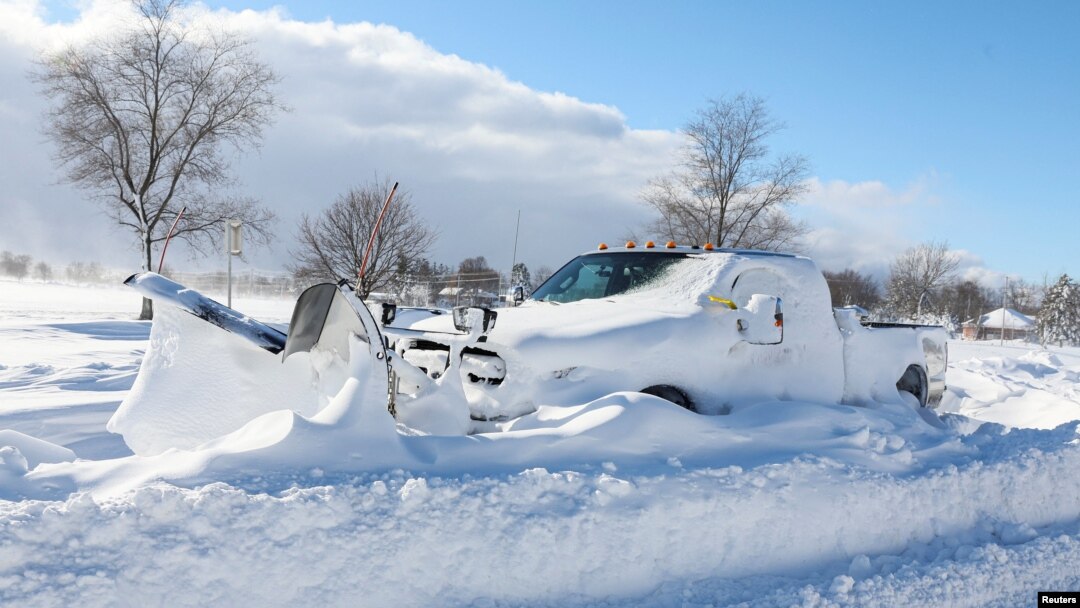 A snow plow is left stranded on the road following a winter storm that hit the Buffalo region on Main St. in Amherst, New York, Dec. 25, 2022.