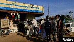 FILE - Customers queue to buy bread at a bakery in Khartoum, Sudan,Feb. 19, 2020. 