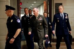 Joint Chiefs Chairman Gen. Joseph Dunford, center, walks to a classified briefing for members of the U.S. Senate on Iran, on Capitol Hill in Washington, May 21, 2019.