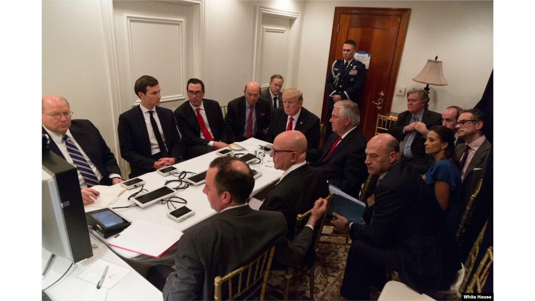 FILE - President Donald Trump receives a briefing on a military strike on Syria from his National Security team on Thursday April 6, 2017, in a secured location at Mar-a-Lago in West Palm Beach, Florida.