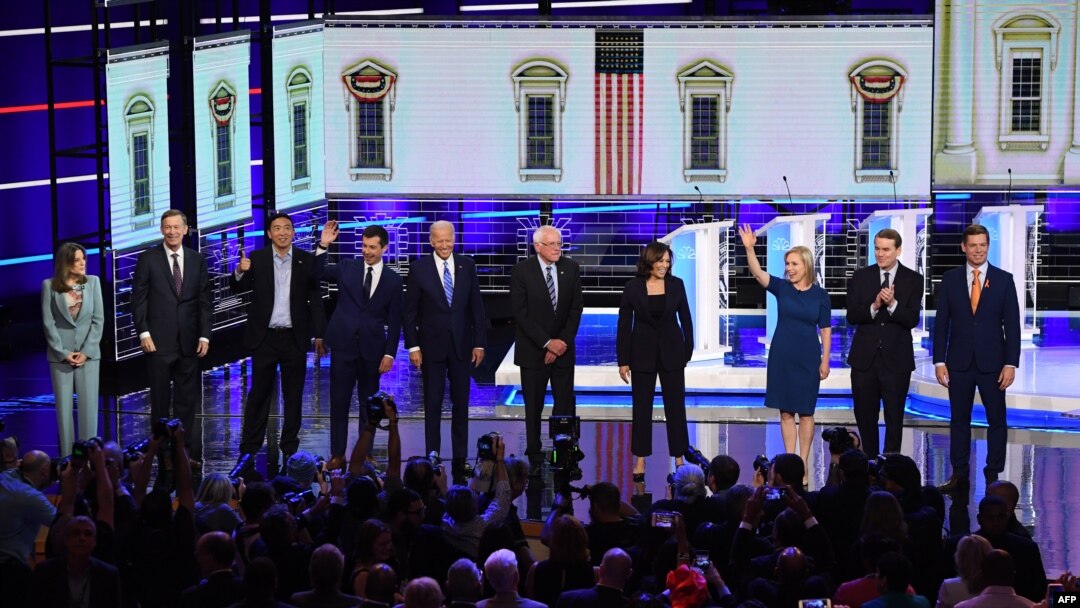 Democratic presidential hopefuls, from left, Marianne Williamson, John Hickenlooper, Andrew Yang, Pete Buttigieg, Joseph R. Biden, Bernie Sanders, Kamala Harris, Kirsten Gillibrand, Michael Bennet, and Eric Swalwell in Miami, June 27, 2019.