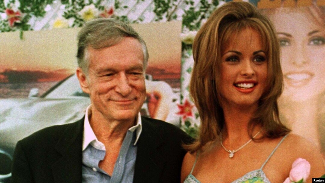 FILE - Karen McDougal, who had recently been named Playboy magazine's Playmate of the Year, poses with Playboy founder Hugh Hefner, May 28, 1998, during ceremonies at the Playboy Mansion in Beverly Hills, California.