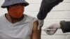 FILE - A volunteer receives an injection from a medical worker during the country's first human clinical trial for a potential vaccine against the novel coronavirus, at Baragwanath Hospital in Soweto, South Africa, June 24, 2020.