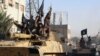 FILE- Islamic States fighters hold a parade in Raqqa, Syria. 