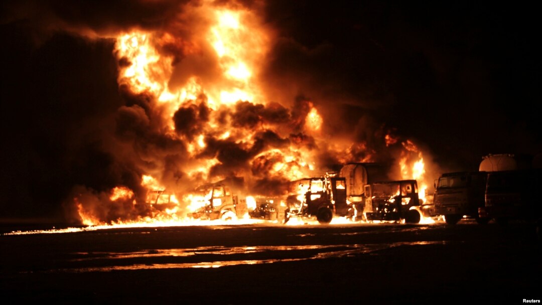 A NATO supply convoy burns after it was attacked in Hub, near Karachi, Pakistan, Sept. 15, 2013.
