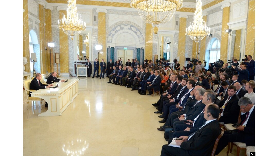 Russian President Vladimir Putin, second left, and Turkish President Recep Tayyip Erdogan, left, hold a news conference in the Konstantin palace outside St. Petersburg, Russia, Aug. 9, 2016.
