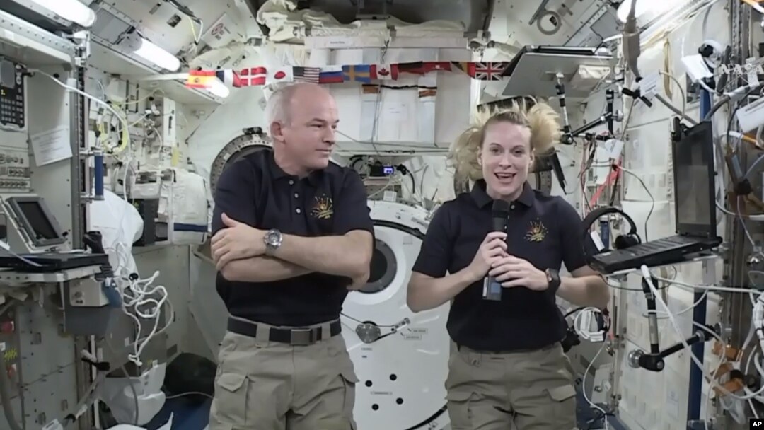 In this image made from video provided by NASA, astronaut Kate Rubins, right, speaks during an interview aboard the International Space Station on July 13, 2016. 