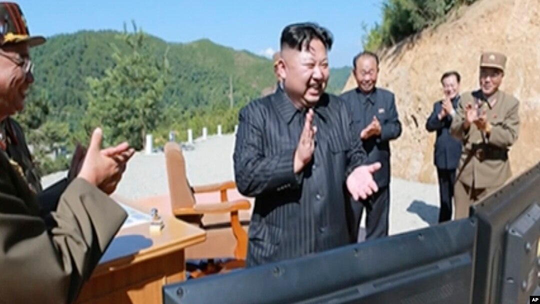 This image made from video aired by North Korea's KRT, July 4, 2017, shows what was said to be North Korea leader Kim Jong Un, center, applauding after the launch of a Hwasong-14 intercontinental ballistic missile in North Korea's northwest.