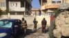 Soldiers search cars and houses for bombs and weapons as they transport detainees in Mosul, Iraq, Jan. 23, 2017. (H. Murdock/VOA)