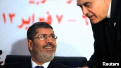 Egyptian President Mohammed Morsi (l) February 6, 2013. 