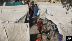 FILE - Internally displaced Afghans from northern provinces, who fled their homes due to fighting between the Taliban and Afghan security forces, shelter in a public park in Kabul, Afghanistan, Aug. 13, 2021. 