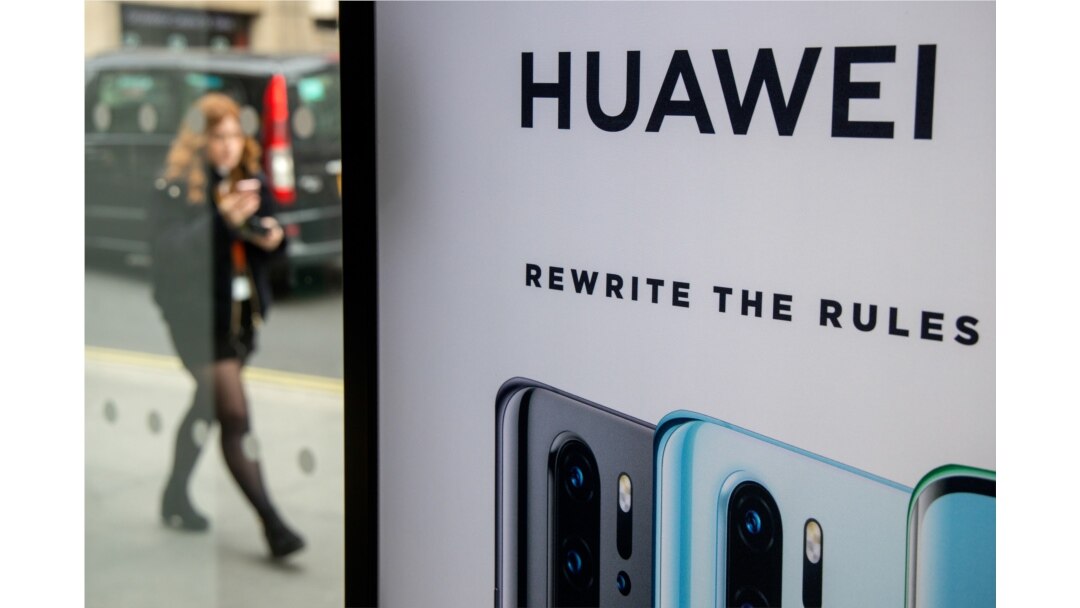 FILE - A pedestrian walks past a Huawei product stand at an EE telecommunications shop in central London, Britain, April 29, 2019.