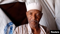 FILE - This displaced Libyan from the city of Tawergha was among those who lived in prefabricated houses for workers at a construction site on the outskirts of Benghazi, July 9, 2012.