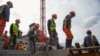 FILE - Workers are seen on a construction site of a concrete arena in Antananarivo, Madagascar, May 22, 2020. 