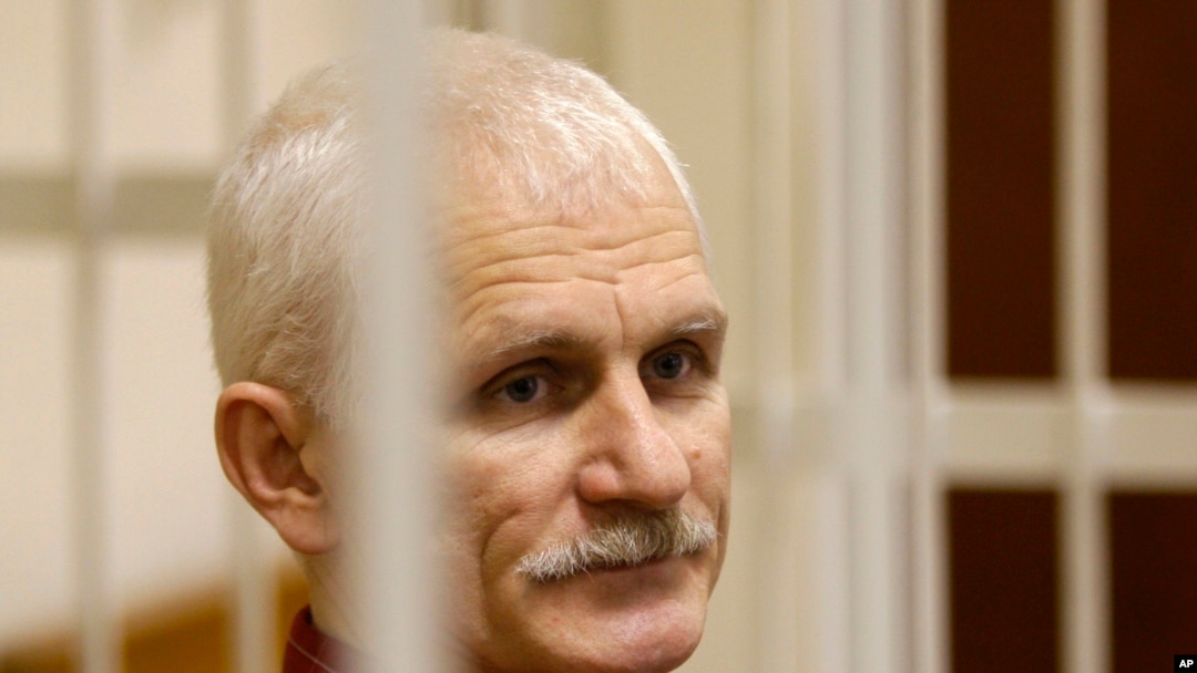 FILE - Ales Bialiatski, the head of Belarusian Vyasna rights group, stands in a defendants' cage during a court session in Minsk, Belarus, on Wednesday, Nov. 2, 2011.