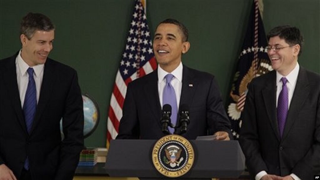 President Barack Obama, flanked by US Education Secretary Arne Duncan, left, and Office of Management and Budget Director Jacob Lew, right, speaks at Parkville Middle School and Center of Technology, in Parkville, Maryland, February 14, 2011