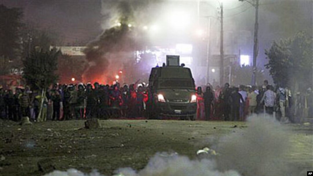 Police fire teargas towards voters who protested, claiming they were prevent from casting their votes in Damas village near El Dakahlia, Egypt, Dec. 5, 2010