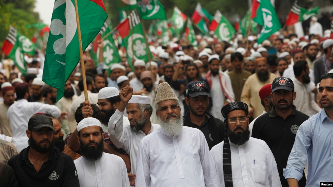 FILE - Sunni cleric Maulana Ahmed Ludhianvi, center, leader of Ahl-e-Sunnat Wal Jamaat (ASWJ), a political and religious group, leads a protest rally in Islamabad, Aug. 22, 2014.