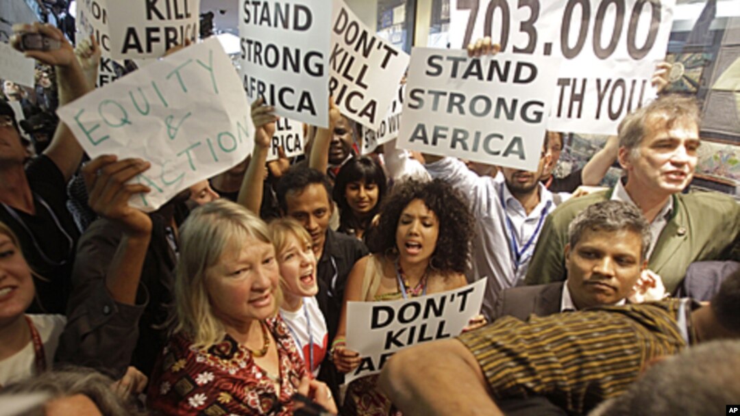 Protesters shout as they demonstrate at the climate change conference in Durban, South Africa, December 9, 2011.