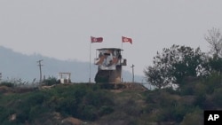 In this May 3, 2020, file photo, a North Korean flag flutters in the wind at a military guard post in Paju, at the border with North Korea.